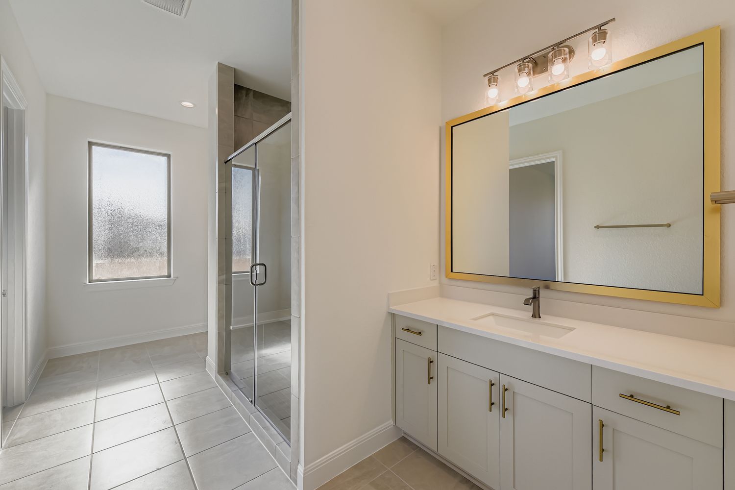 395 Prickly Poppy Loop Kyle, TX 78640 - Photo 7 of 11 a bathroom with a double vanity sink and a mirror