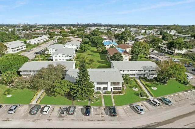 an aerial view of residential houses with outdoor space and ocean view