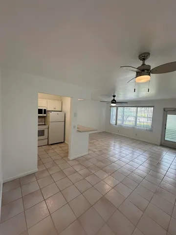 a view of a kitchen with cabinets and stainless steel appliances