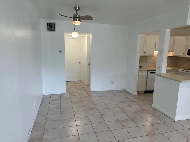 a view of a kitchen with a sink and a refrigerator