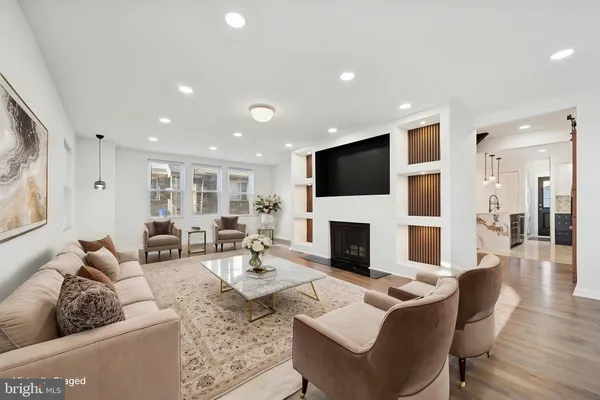 a living room with fireplace furniture and a flat screen tv