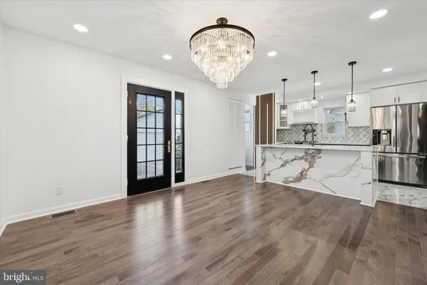 a view of a kitchen with wooden floor and a large window