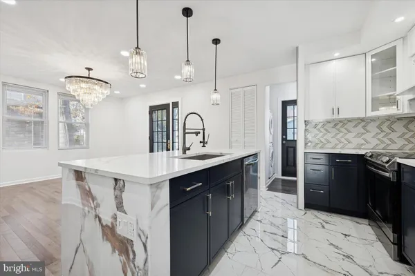 a kitchen with granite countertop a sink appliances and cabinets