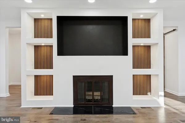 a living room with a fireplace and a flat screen tv