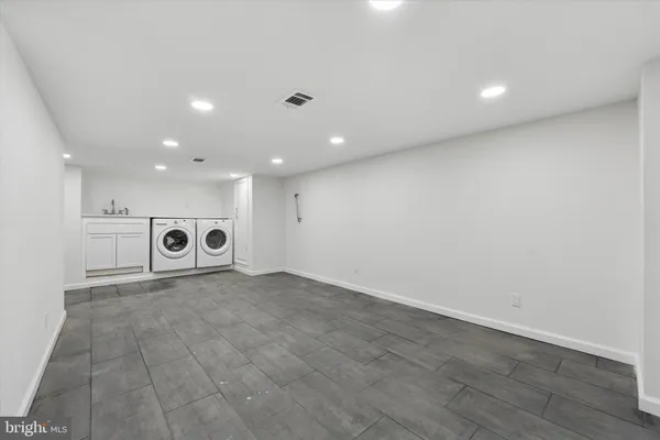 a kitchen with a sink and a mirror