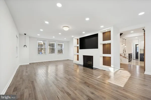a view of a living room with a flat screen tv and fireplace
