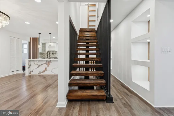 a view of entryway and hall with wooden floor