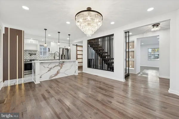 a view of a kitchen with wooden floor and a kitchen