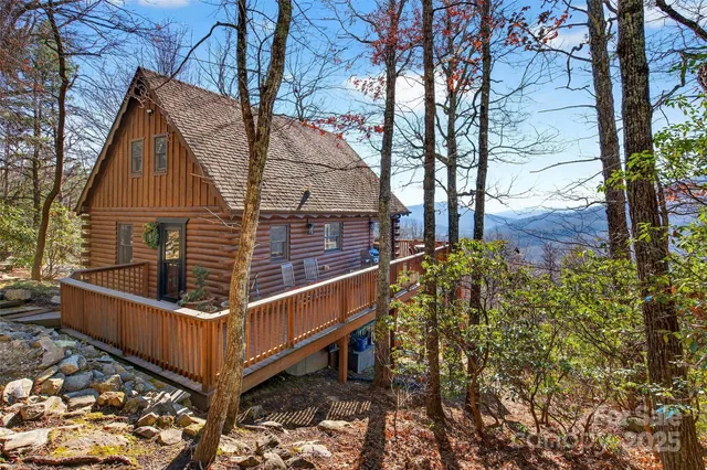 a view of backyard with deck and wooden fence
