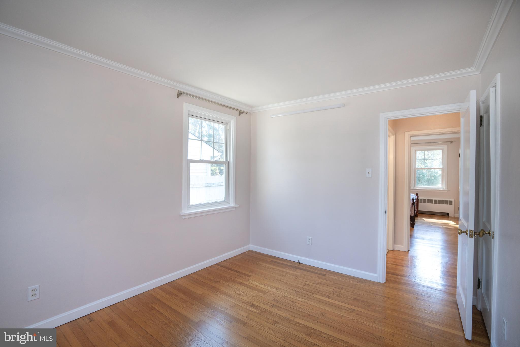 422 Martin Terrace State College, PA 16803 - Photo 14 of 56 a view of an empty room with wooden floor and a window