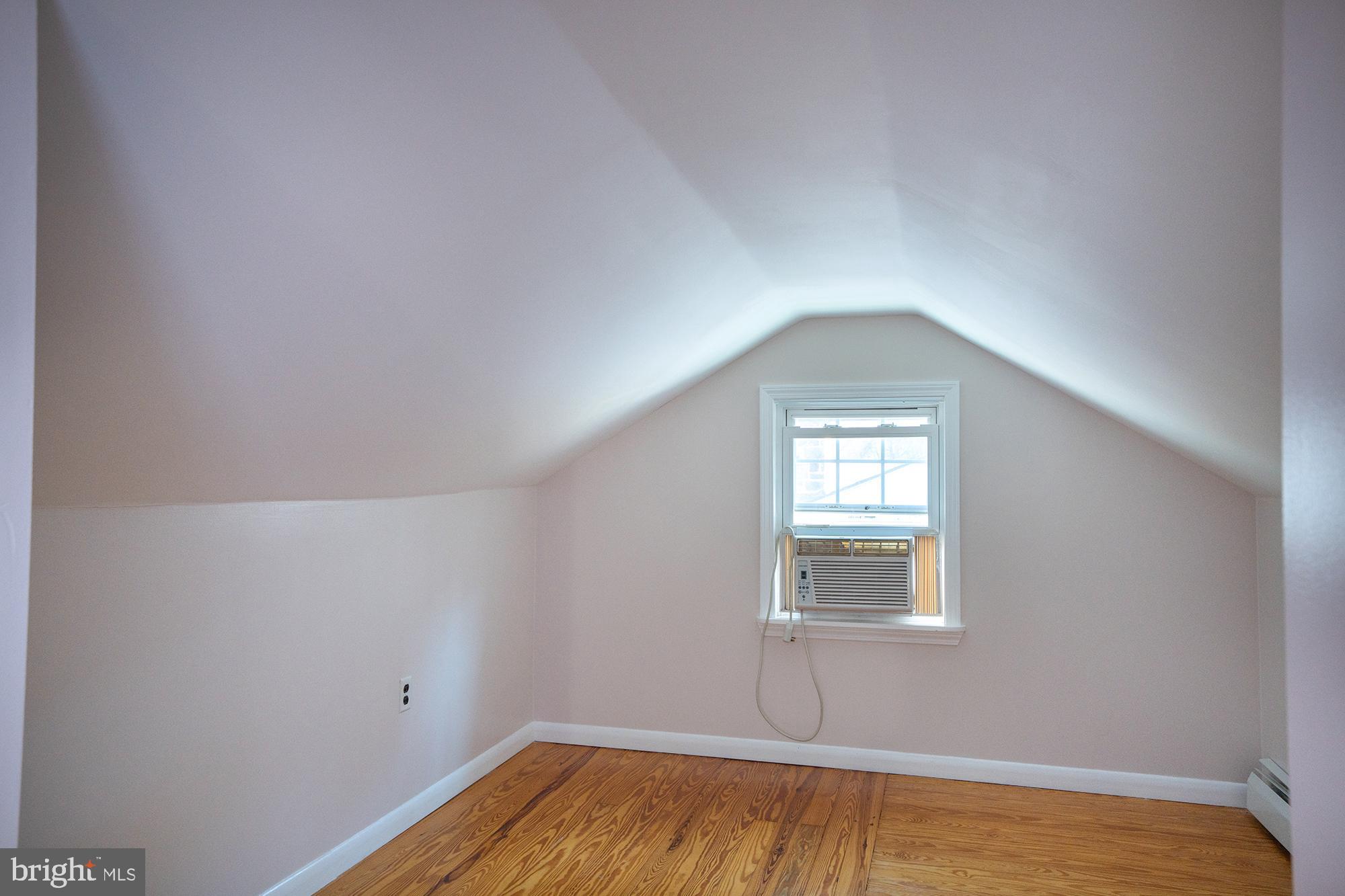 422 Martin Terrace State College, PA 16803 - Photo 32 of 56 a view of an empty room with wooden floor and a window