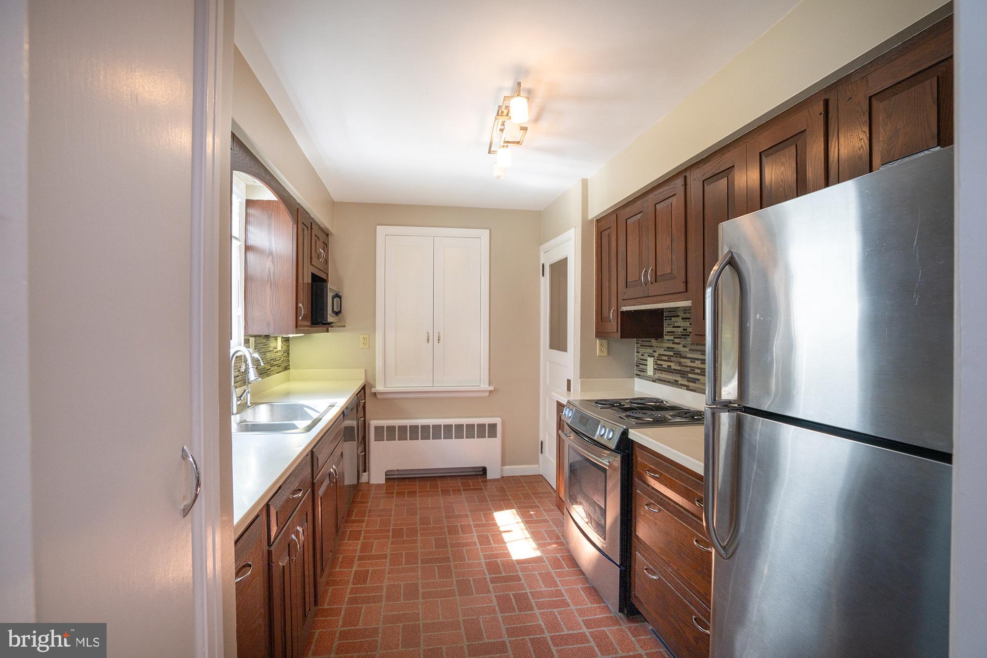 422 Martin Terrace State College, PA 16803 - Photo 9 of 56 a kitchen with a refrigerator a sink and a stove top oven