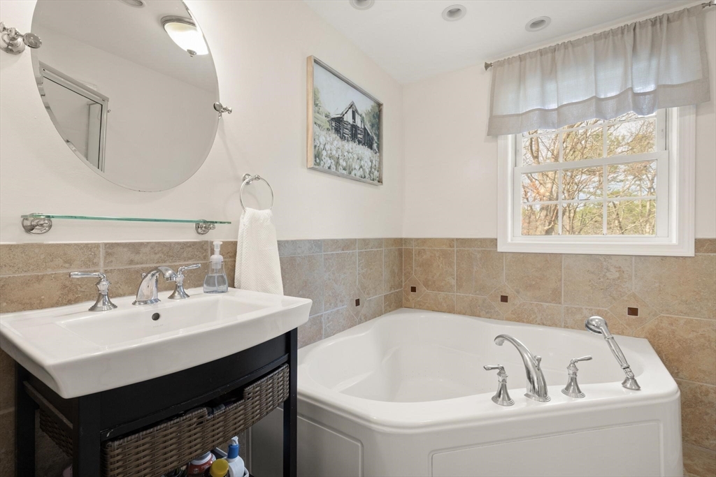 41 Chestnut Road Tyngsborough, MA 01879 - Photo 20 of 32 a bathroom with a bathtub and a sink