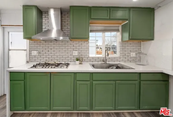 a bathroom with a sink a window and a mirror