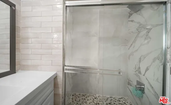 a bathroom with a shower and a sink