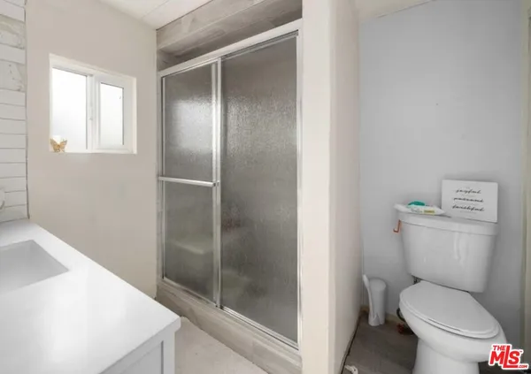a white toilet sitting next to a bathroom sink