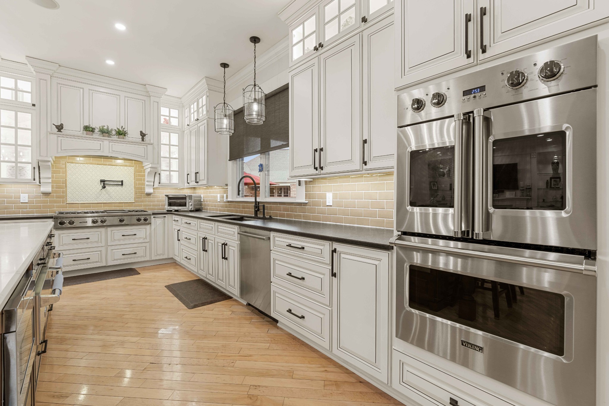 107 Tiffany Court Franklin, TN 37064 - Photo 17 of 98 a kitchen with stainless steel appliances white cabinets a sink a stove a microwave and wooden floors