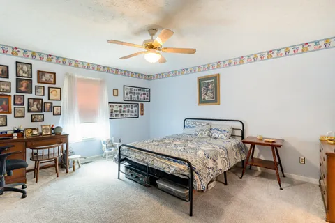a bedroom with a bed and a chandelier