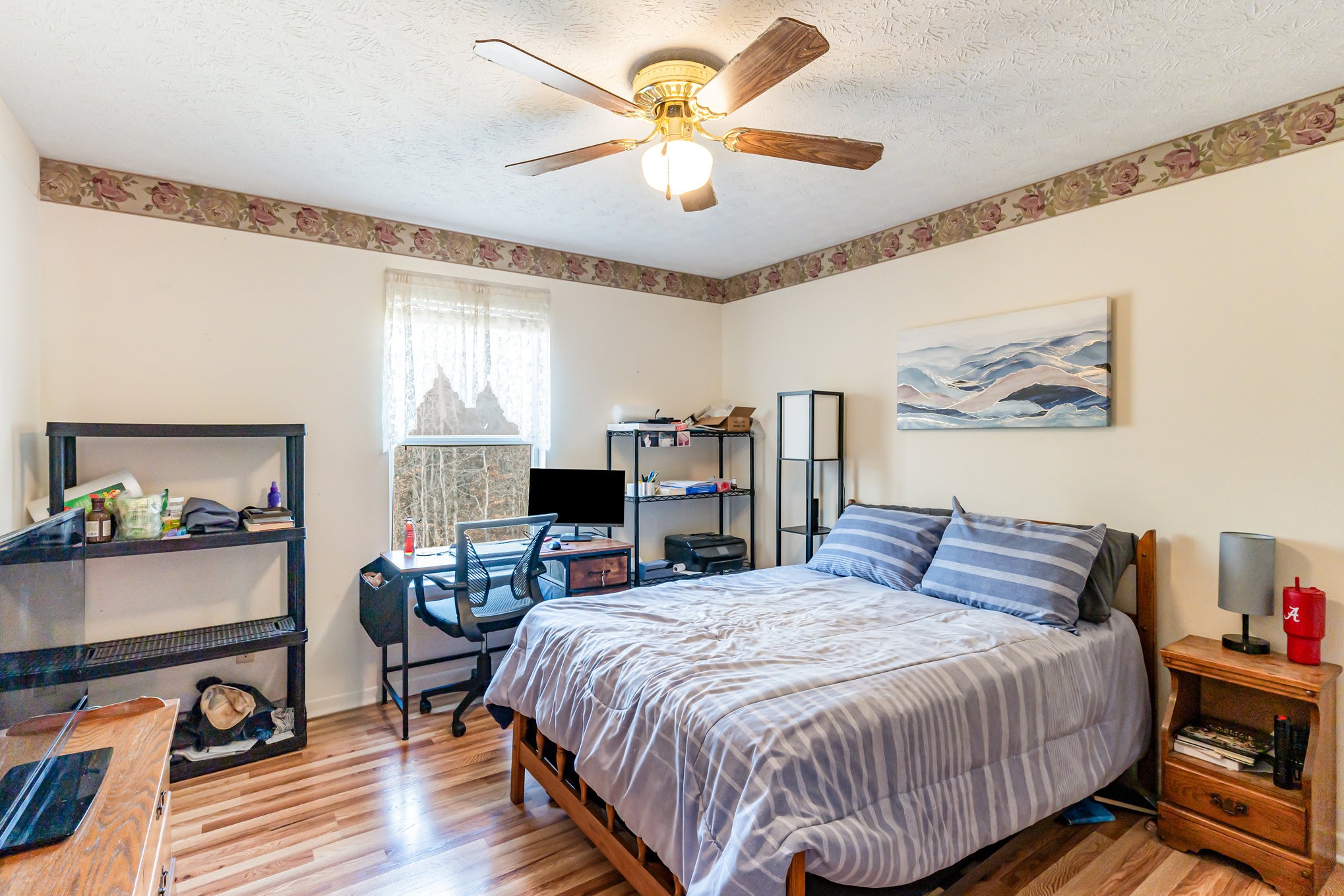 1180 Simms Heights Road Kingston Springs, TN 37082 - Photo 15 of 31 a bedroom with a bed and a chandelier