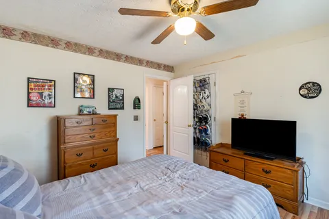 a bedroom with a bed and a flat screen tv