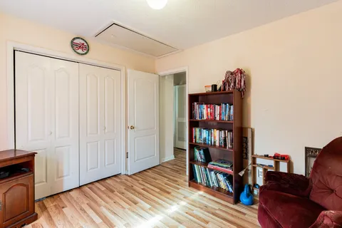 a bed room with a bed and a book shelf