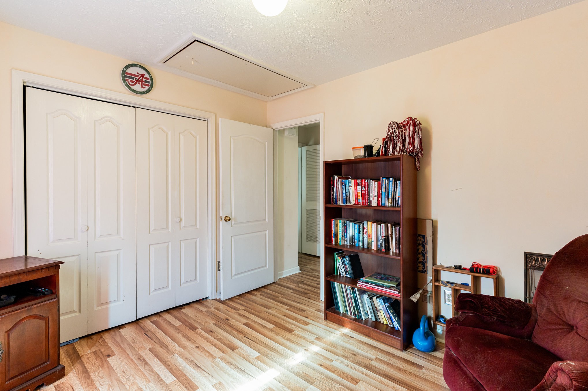 1180 Simms Heights Road Kingston Springs, TN 37082 - Photo 19 of 31 a bed room with a bed and a book shelf