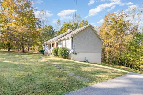 a view of a house with a yard and garage