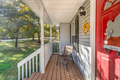 a view of balcony with wooden floor and outdoor seating
