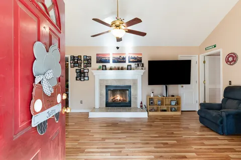 a living room with furniture a flat screen tv and a fireplace