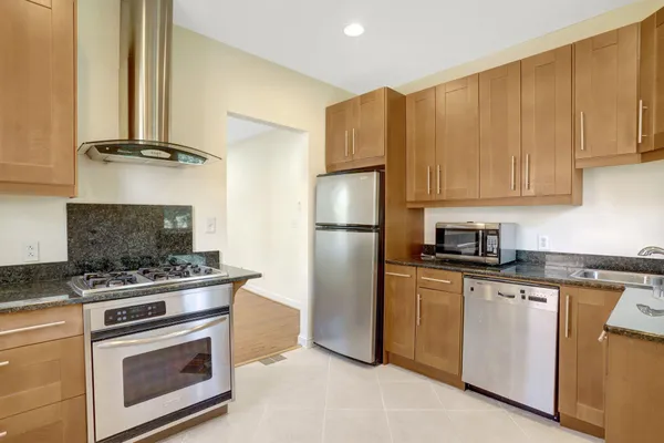 an empty room with a window and a ceiling fan