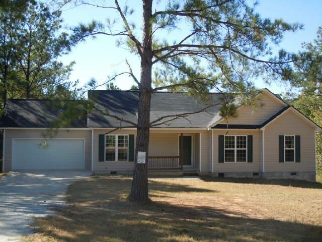 297 Anderson Road Griffin, GA 30223 - Photo 1 of 1 a view of a yard in front of a house with large tree
