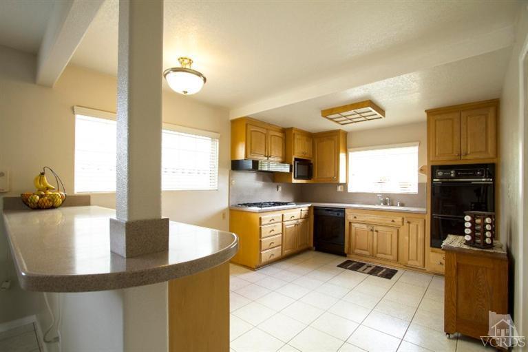 2169 Rhoda Street Simi Valley, CA 93065 - Photo 7 of 21 a kitchen with stainless steel appliances granite countertop a sink dishwasher stove top oven and cabinets