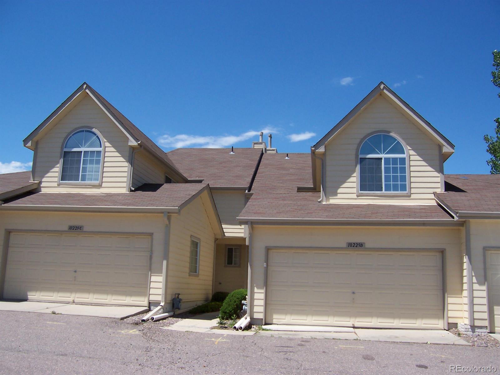 a front view of a house with garage