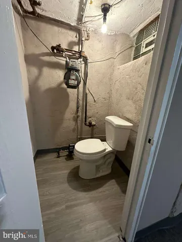 a white toilet sitting next to a shower