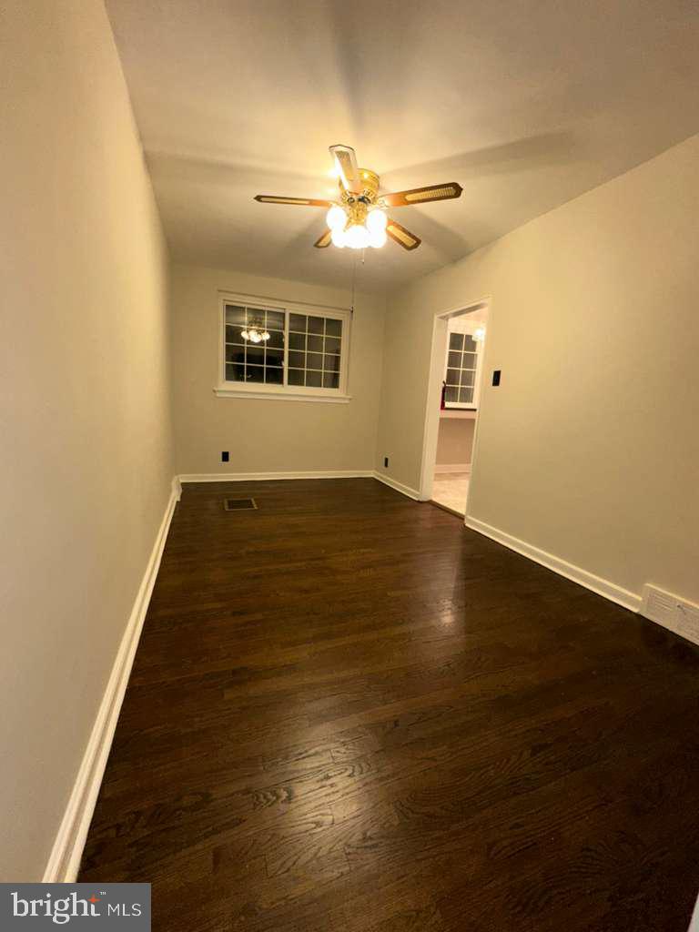 8509 Temple Road Philadelphia, PA 19150 - Photo 4 of 16 an empty room with wooden floor fan and windows