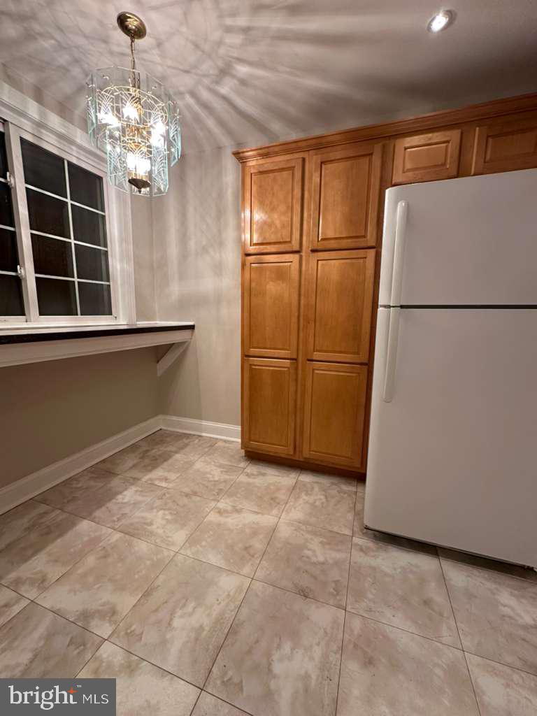 8509 Temple Road Philadelphia, PA 19150 - Photo 7 of 16 a view of a kitchen with a refrigerator and microwave