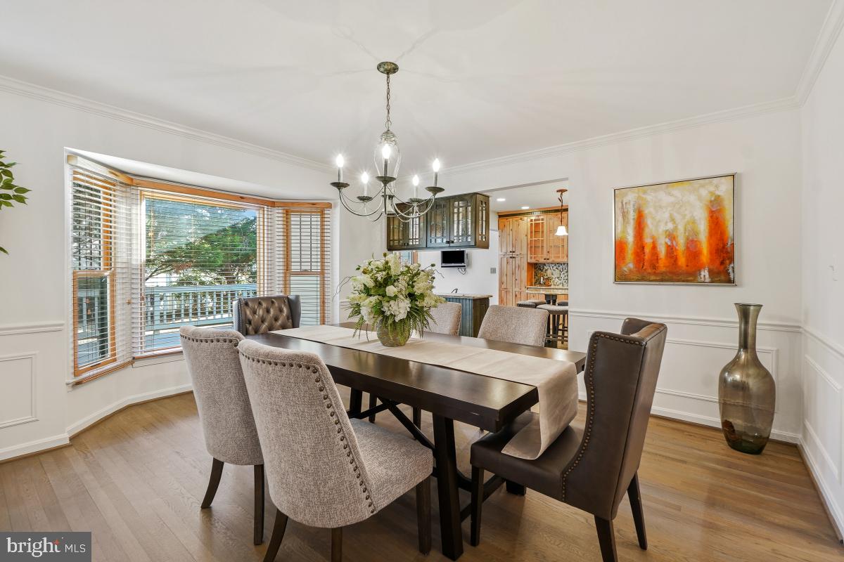 9804 Korman Court Potomac, MD 20854 - Photo 12 of 66 a dining room with furniture a livingroom and chandelier