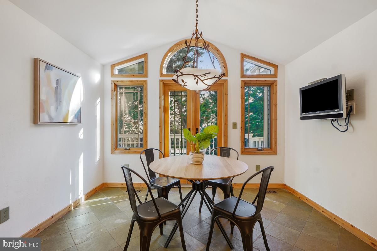 9804 Korman Court Potomac, MD 20854 - Photo 14 of 66 a view of a dining room with furniture window and wooden floor