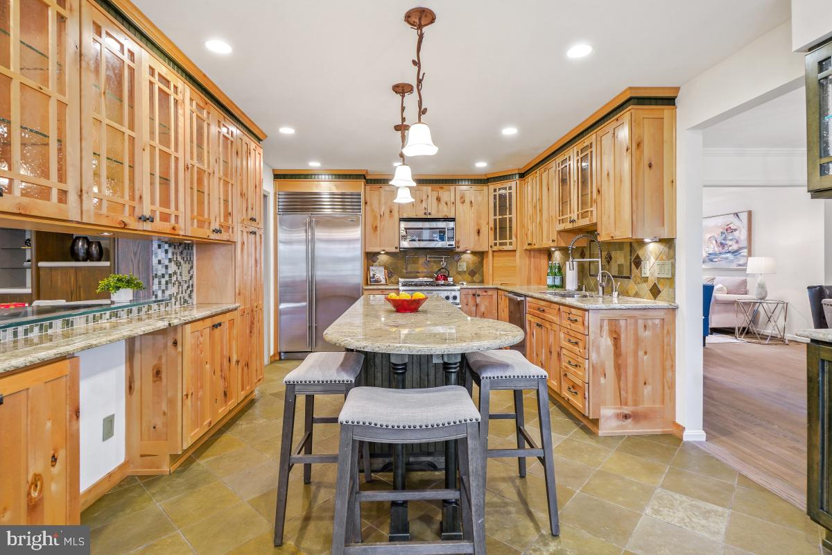 9804 Korman Court Potomac, MD 20854 - Photo 17 of 66 a large kitchen with a table and chairs