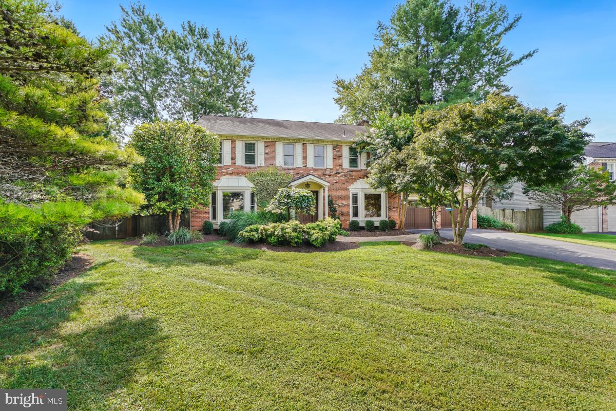 9804 Korman Court Potomac, MD 20854 - Photo 2 of 66 a front view of a house with a garden