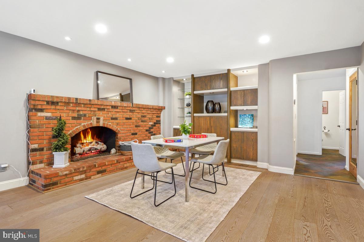 9804 Korman Court Potomac, MD 20854 - Photo 27 of 66 a living room with furniture a fireplace and a table