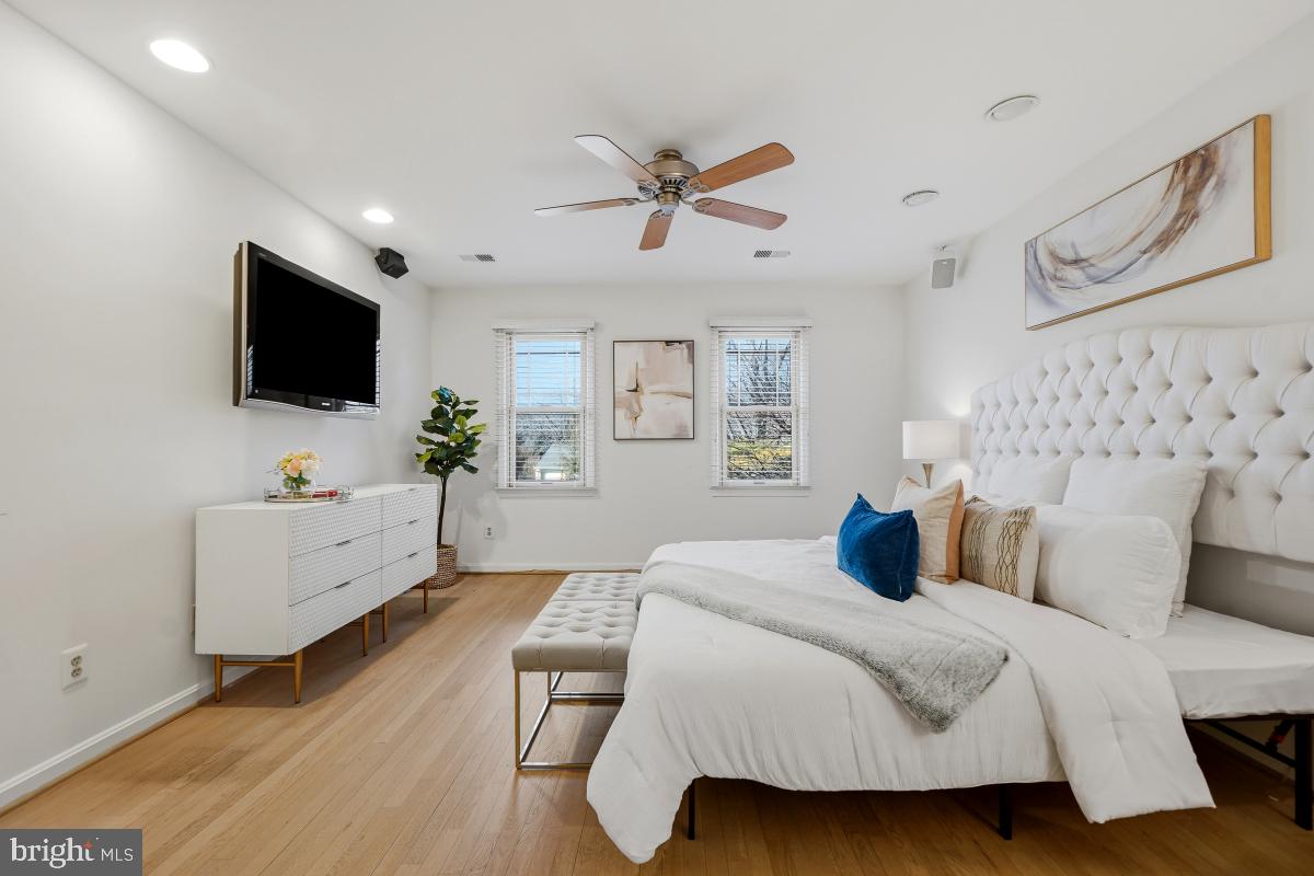 9804 Korman Court Potomac, MD 20854 - Photo 32 of 66 a bedroom with a bed and a flat screen tv