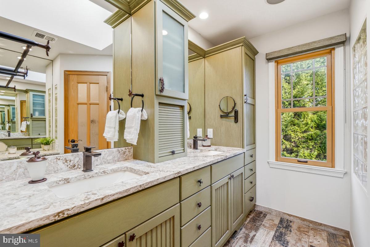 9804 Korman Court Potomac, MD 20854 - Photo 37 of 66 a bathroom with a granite countertop sink and a mirror