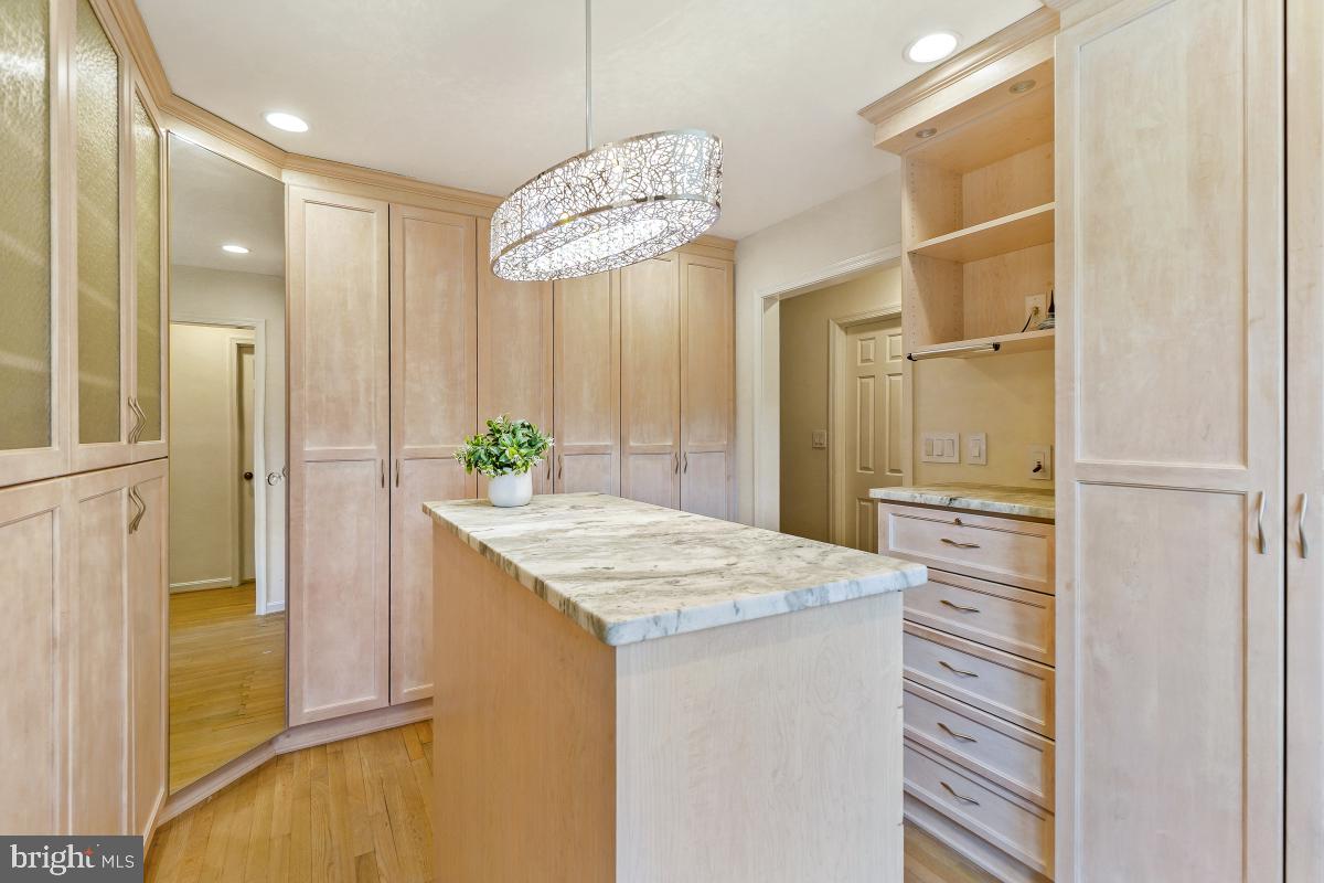 9804 Korman Court Potomac, MD 20854 - Photo 39 of 66 a bathroom with a granite countertop sink a mirror and a shower