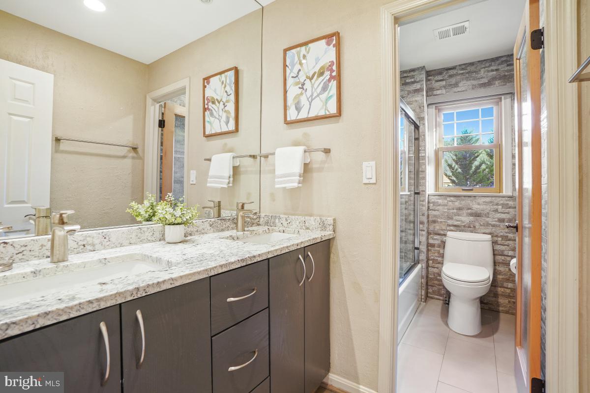 9804 Korman Court Potomac, MD 20854 - Photo 42 of 66 a bathroom with a granite countertop sink mirror and toilet