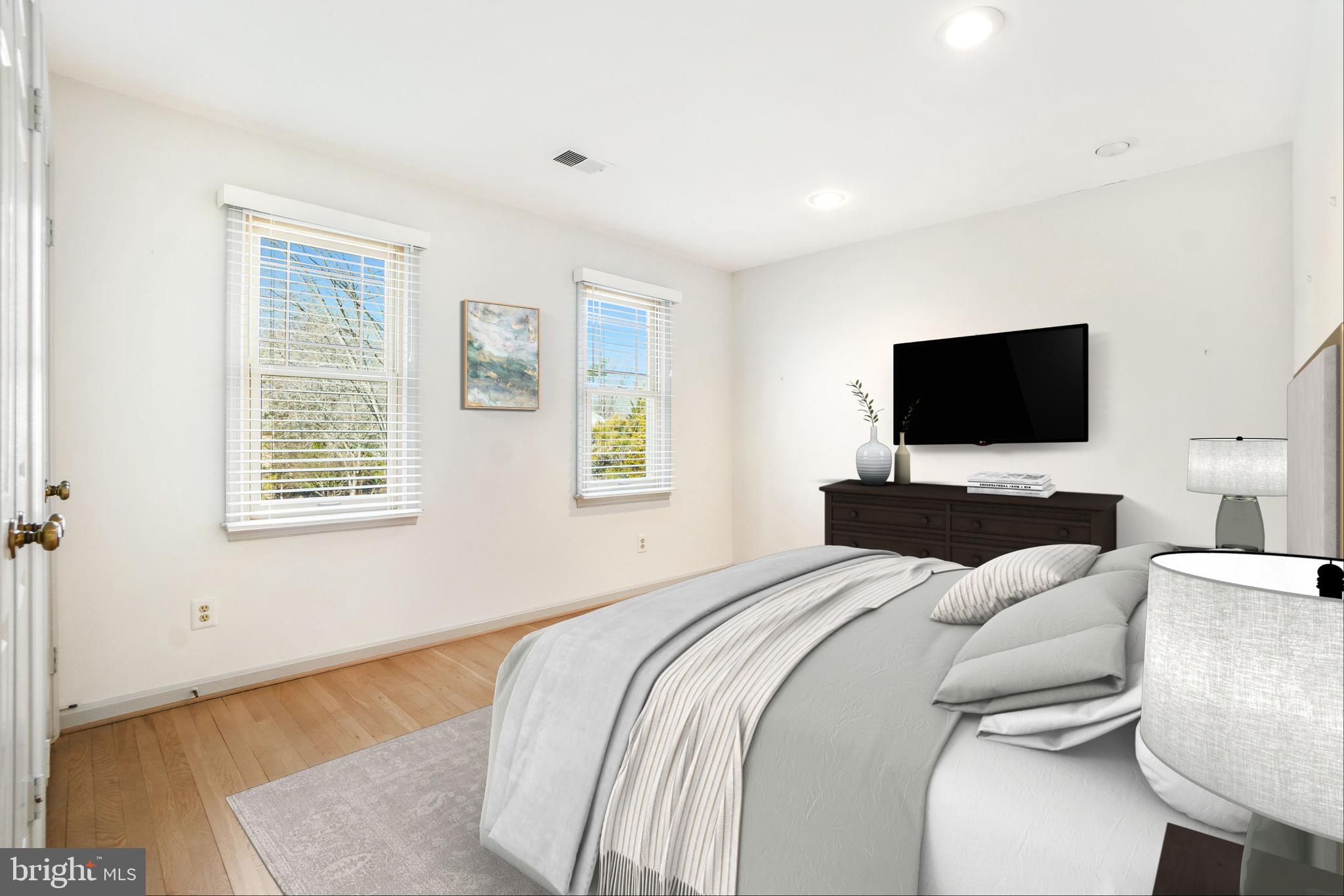 9804 Korman Court Potomac, MD 20854 - Photo 44 of 66 a bedroom with a bed and a flat screen tv