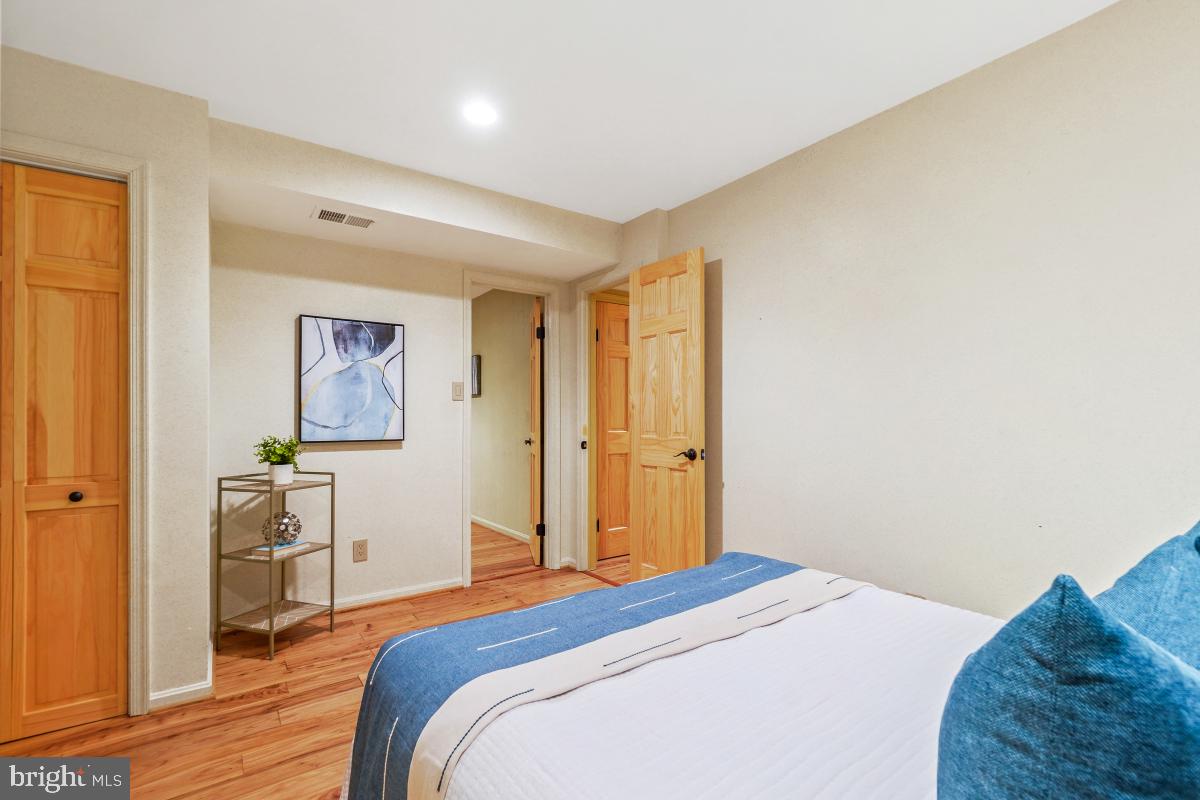 9804 Korman Court Potomac, MD 20854 - Photo 53 of 66 a bedroom with a bed and a painting on the wall