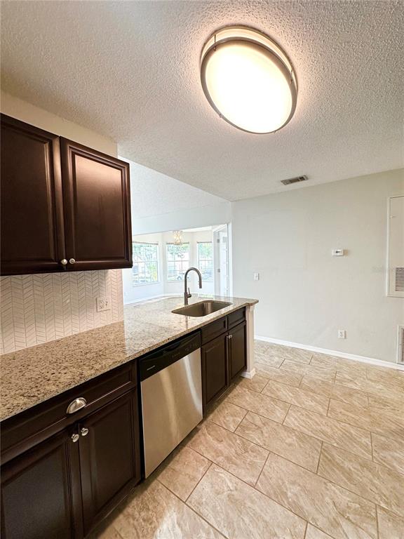 654 Roaring Drive, Unit 228 Altamonte Springs, FL 32714 - Photo 11 of 37 a large kitchen with granite countertop a sink and a stove
