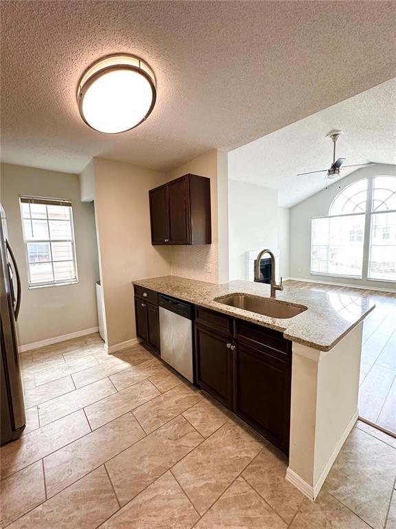654 Roaring Drive, Unit 228 Altamonte Springs, FL 32714 - Photo 14 of 37 a kitchen with stainless steel appliances granite countertop a sink and a stove