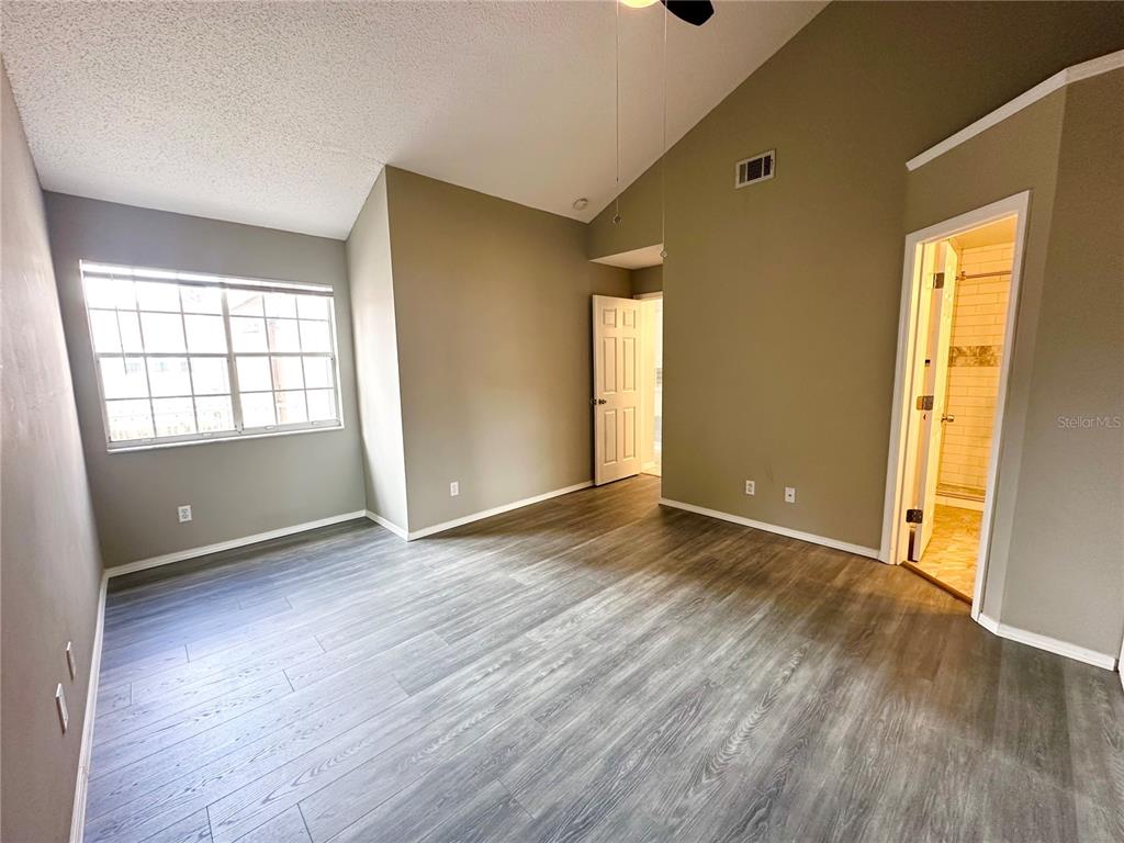 654 Roaring Drive, Unit 228 Altamonte Springs, FL 32714 - Photo 20 of 37 an empty room with wooden floor and windows